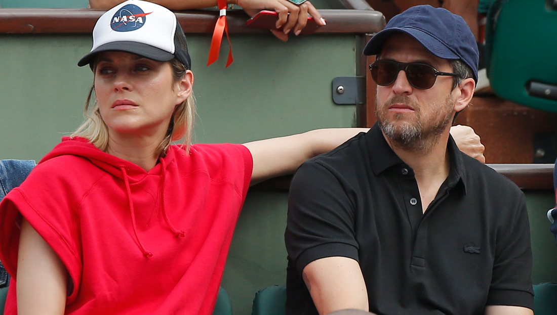 French actress Marion Cotillard and French actor and director Guillaume Canet watch the men's final match of the French Open tennis tournament at the Roland Garros stadium in Paris