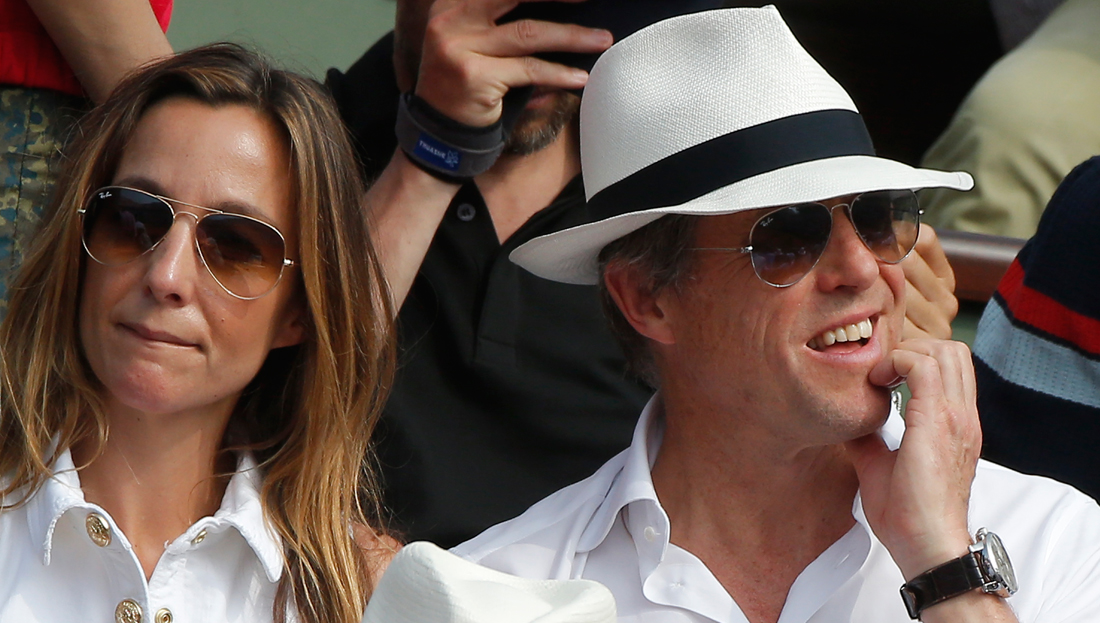 British actor Hugh Grant and his wife Anna Elisabet Eberstein watch the men's final match of the French Open tennis tournament at the Roland Garros stadium in Paris